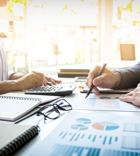 business man financial inspector and secretary making report, calculating or checking balance. Internal Revenue Service inspector checking document. Audit concept